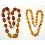 Two amber necklaces, some with swirl pattern ribbing, some beads are pressed amber, length 60 cm,