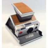 Early poloroid camera sx-70, 1972, model 1 aluminium and Leather, serial number h303463038, in
