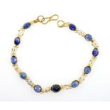 Fine gold bracelet set with oval sapphires, the faceted stones collet set in 14 ct gold, length 16