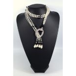 Cultured pearl sautoir necklace, strung as four rows suspended from a crystal set ring, each