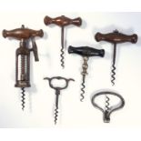 A group of antique wine corkscrews, 19thC steel open barrel corkscrew, five others including a