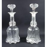 A pair of antique wrythen glass bell form decanters, C. 1830, height 31 cm.
