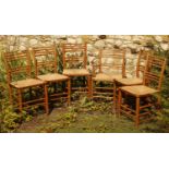 Set of six William Morris style Sussex chairs with rush seats, one carver and five chairs.