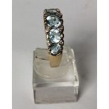 Vintage aquamarine and diamond set ring, five vibrant faceted stones and small diamond accents in