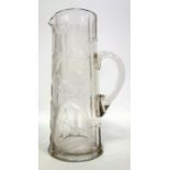Early 20th C. glass jug facet cut, with wheel cut engraving of lilies, 30 cm.