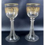 A pair of 19th C. goblets with gilt decoration, on trumpet form ribbed stems, height 23 cm.