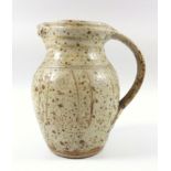 Jim Malone, born 1946, an ash glazed jug, with incised decoration and strap handle, 19.5 cm and a