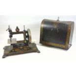 Victorian travelling sewing machine, A sewing machine, the japanned and gilt decorated frame