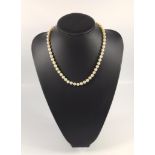 Cultured pearl necklace with a gold bead clasp, pearls 7mm, marked for 14ct gold, length 51cm, boxed