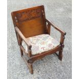 Oak Monk?s seat with a carved tilting and sliding back/top, on splayed supports and stretcher.