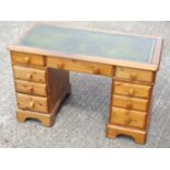 Victorian style pine pedestal desk with a gilt tooled leather top and 9 drawers, on bracket feet, W.
