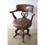 Late Victorian mahogany desk armchair with a carved and pierced splat back and upholstered revolving