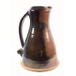 Mike Braisher large stoneware jug with red and brown glaze and scroll handle, impressed mark, 35 cm