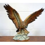 Capodimonte model of an eagle with wings outstretched, perched on a craggy rock, signed V. Binoli, H