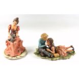 Capodimonte group of a girl and boy about to kiss, W 25.5cm and a group of a woman seated with a