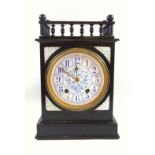 A late Victorian ebonised mantel clock, with galleried to over a blue floral printed dial with