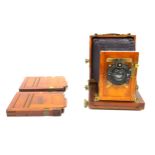 A 19th century Ashford?s Patent, mahogany cased folding field camera, together with two plate