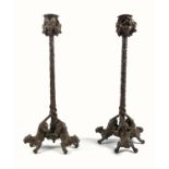 An interesting pair of 19th century French bronze candlesticks, the urn shaped sconces applied