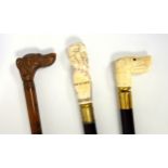 A 19th century ivory mounted walking cane, the pommel carved as a Head Showing Four Kinds