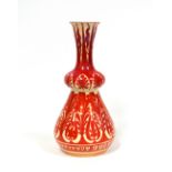 A William de Morgan style red lustre pottery Persian shape vase decorated with repeating scrolling