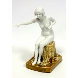 Continental Art Deco porcelain figure of a nude woman sitting on a ?dragon? draped stool, on a