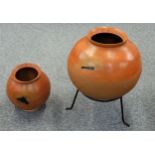 African sphericle terracotta pot with a flared rim, Dia. 47 cm on metal stand and a similar