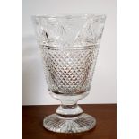 A heavy Stuart Crystal cut glass and etched vase with swags and hob nail cut decoration on a