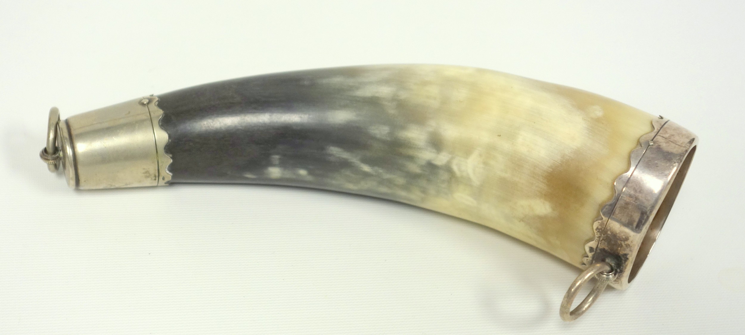 A Continental white metal mounted drinking horn, possibly German, bearing marks, 23 cm long