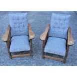 Pair of Art Deco oak fireside chairs, each with slatted sides and spreading arms, with an adjustable