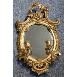 A 19th century gilt wood and gesso girandole with C scroll cresting, moulded frame with foliate