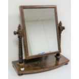 A Victorian mahogany dressing table mirror, the rectangular swing plate flanked by unusual ring