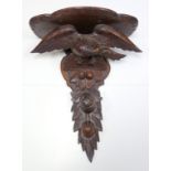 Black Forest carved wood wall bracket with an eagle and fruit, H 60.5cm