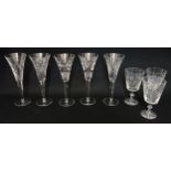 A near matched suite of twelve Waterford crystal cut glass champagne flutes on facetted tapering