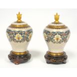 Pair of Chinese cloisonné floral decorated vases, each with a cover, H 13.5cm, on a carved wood