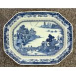 An early 19th century Chinese porcelain octagonal meat plate, decorated in under glaze blue with two