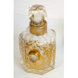 A late 19th century French heptagonal glass scent bottle and stopper highlighted in gilt with an