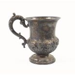 William IV silver baluster child?s mug with embossed floral decoration and scroll handle, on a