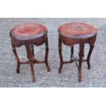 A pair of late 19th/20th century Chinese hardwood stools on shaped legs united by X stretchers