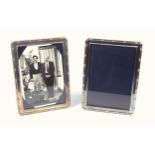 Pair of silver mounted rectangular photograph frames with a ribbon and reeded border, by Richard