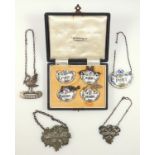 Silver decanter label in the form of a swan, two white metal labels and five ceramic labels, with