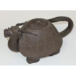 A Chinese Yixing pottery ?dragon? teapot and cover, with open mouth and twisted tail, the body