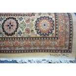 Persian carpet, the ivory field with an indigo anchor medallion and all over floral decoration 375