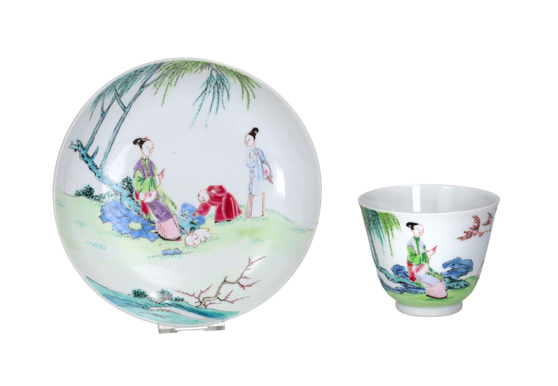 A famille rose porcelain cup and saucer decorated with figures and a hare in the garden. China,