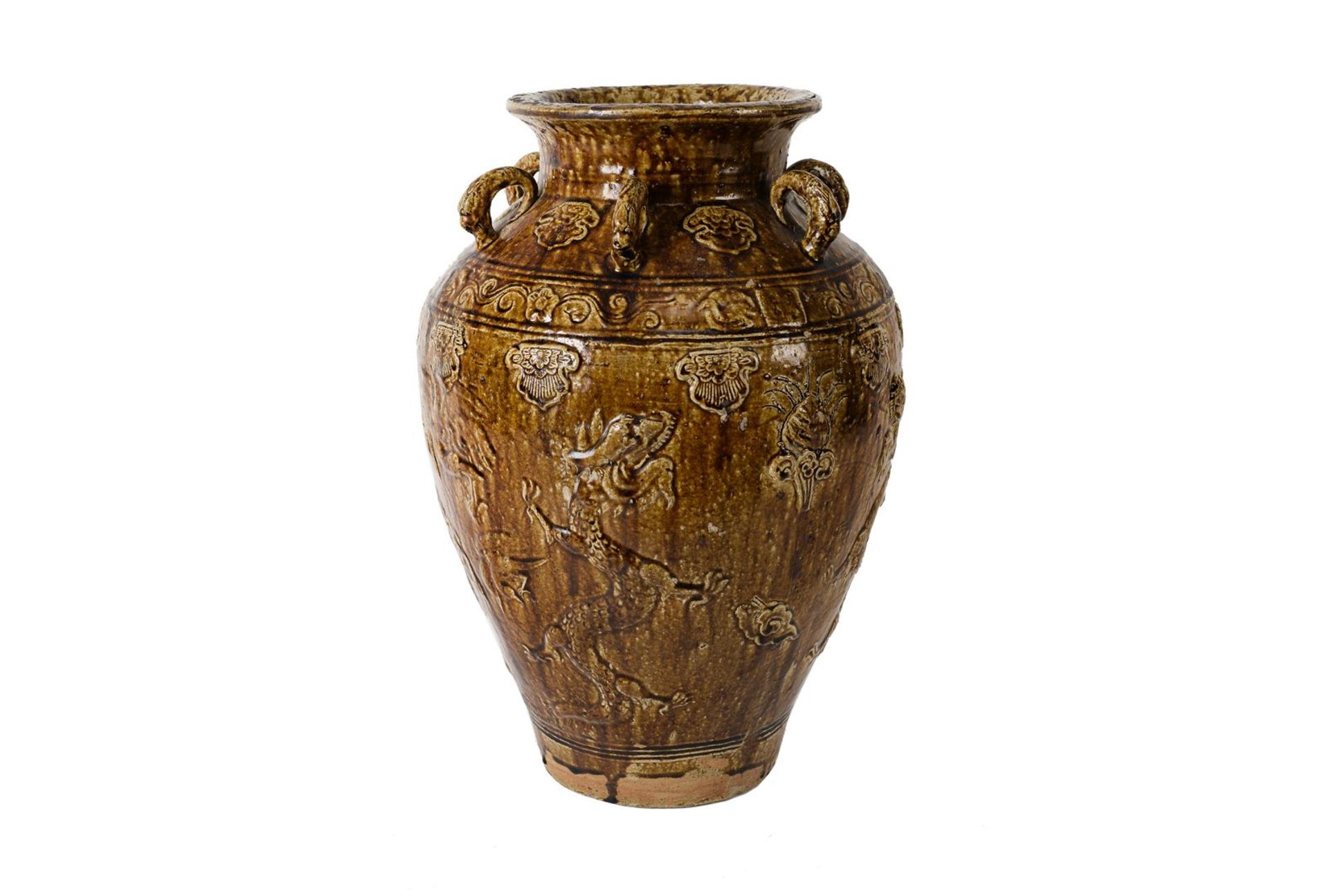 A glazed pottery martaban jar with six rings, decorated in relief with dragons and flowers.