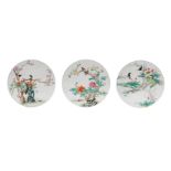 Lot of three round polychrome porcelain plaques, all decorated with flowers and birds. Unmarked.