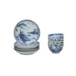 A set of five blue and white miniature porcelain cups and saucers decorated with a landscape decor