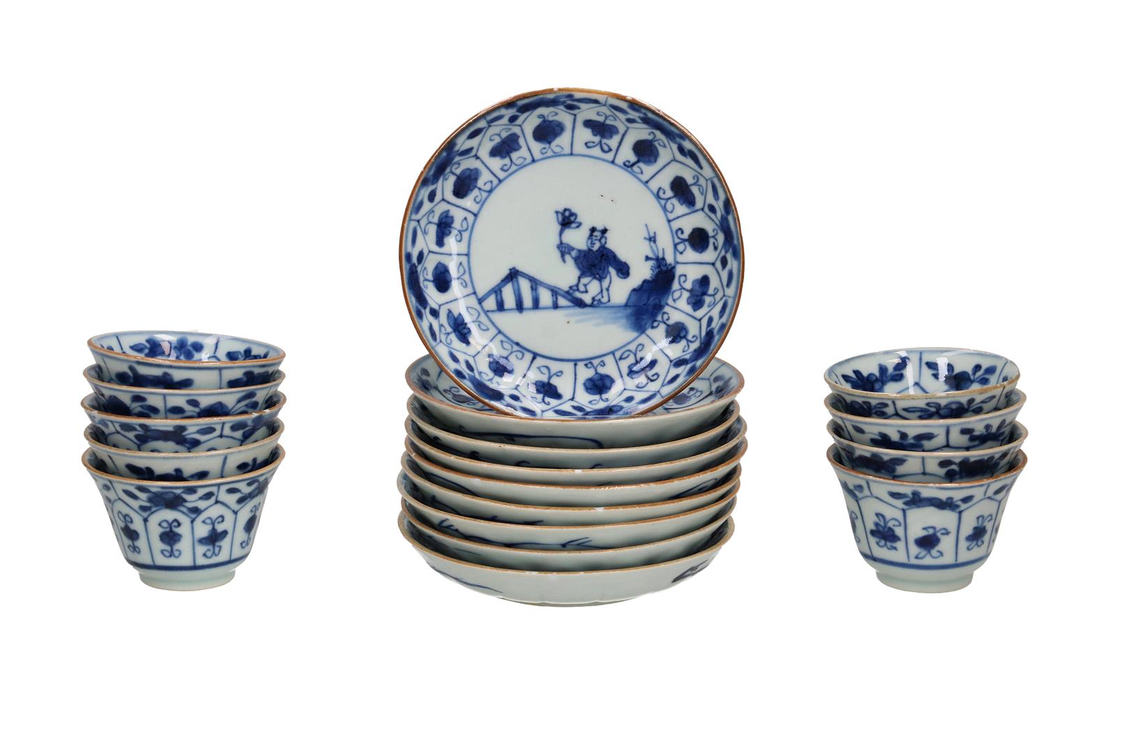 A set of nine blue and white porcelain cups and saucers decorated with a little boy with a blossom