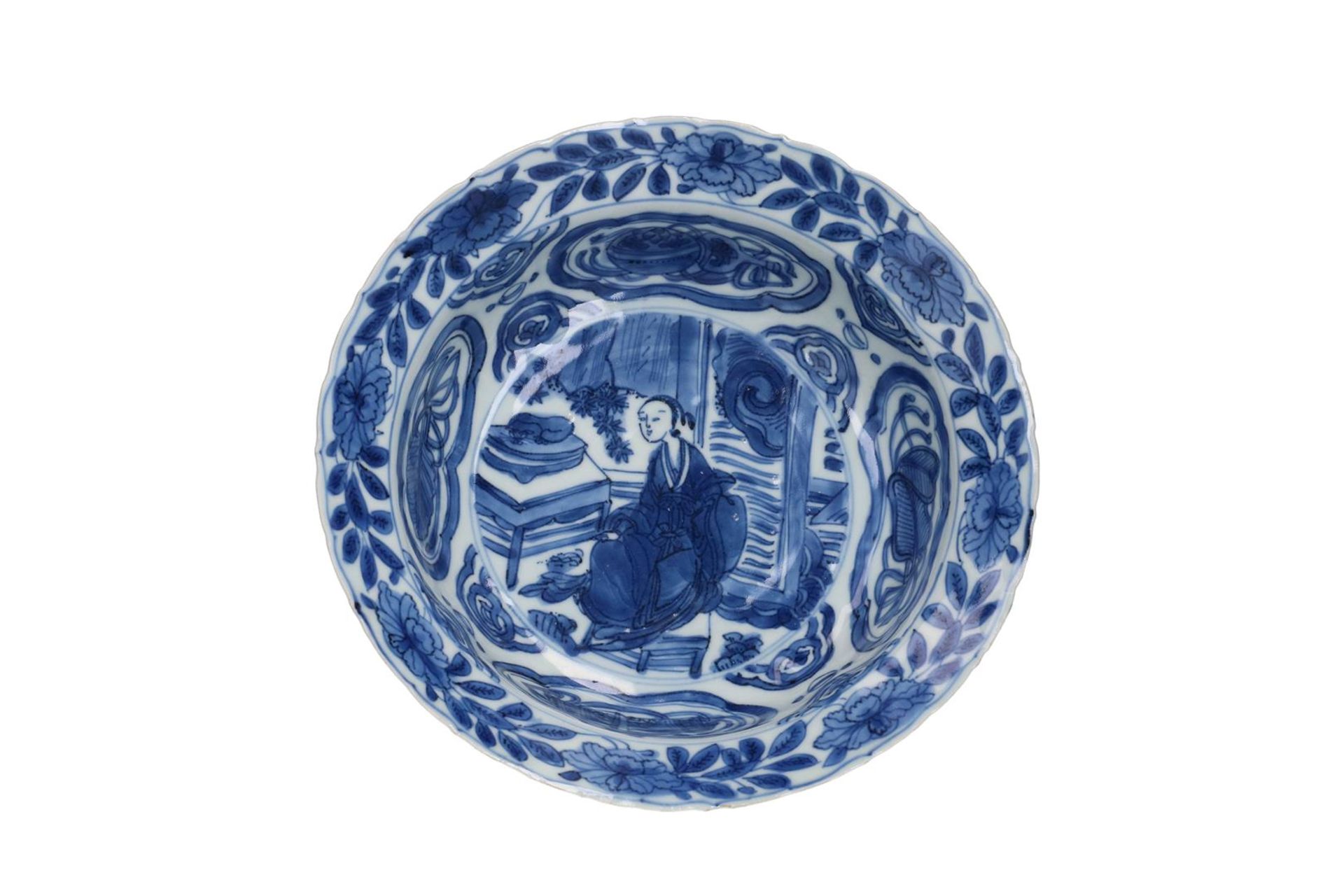 A blue and white porcelain 'klapmuts' bowl with a decoration of Long Eliza sitting at the table with