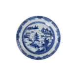 A blue and white porcelain charger, decorated with pagodas in a river landscape. Unmarked. China,