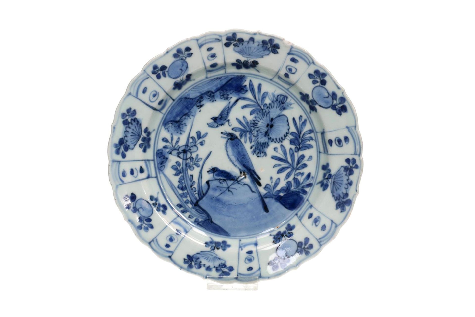 A blue and white 'kraak' porcelain dish with a scalloped rim, decorated with birds on a rock and